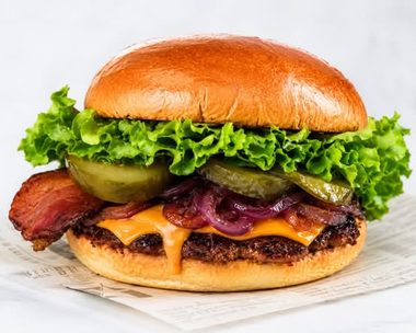 The Rickey OG: rundsvleesburger met cheddar, bacon, augurk en gekarameliseerde uitjes op een briochebroodje